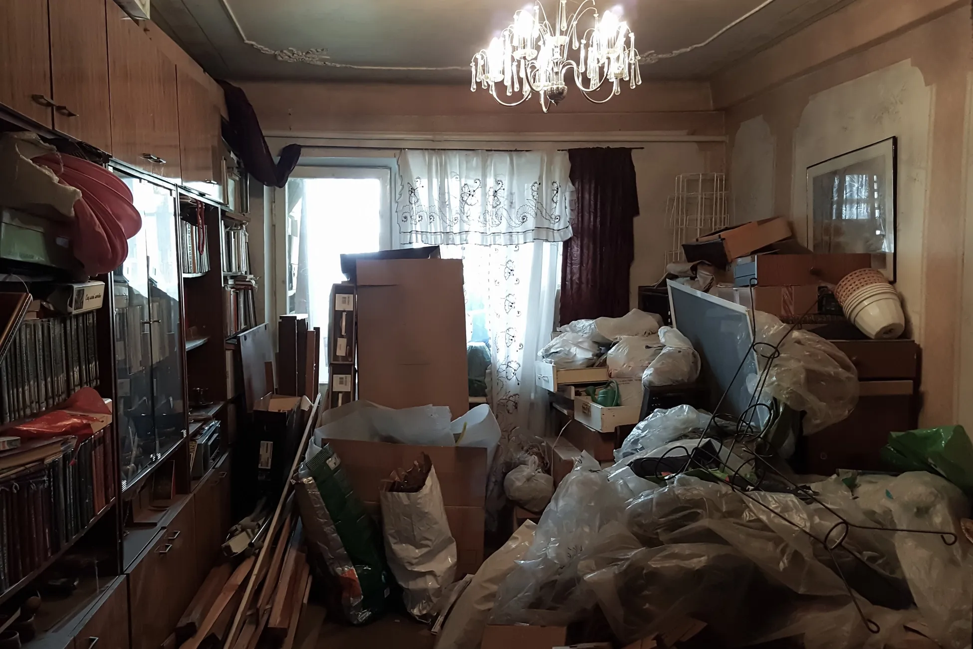 A Brooklyn basement packed with furniture and clutter before Strictly Junk Removal arrived
